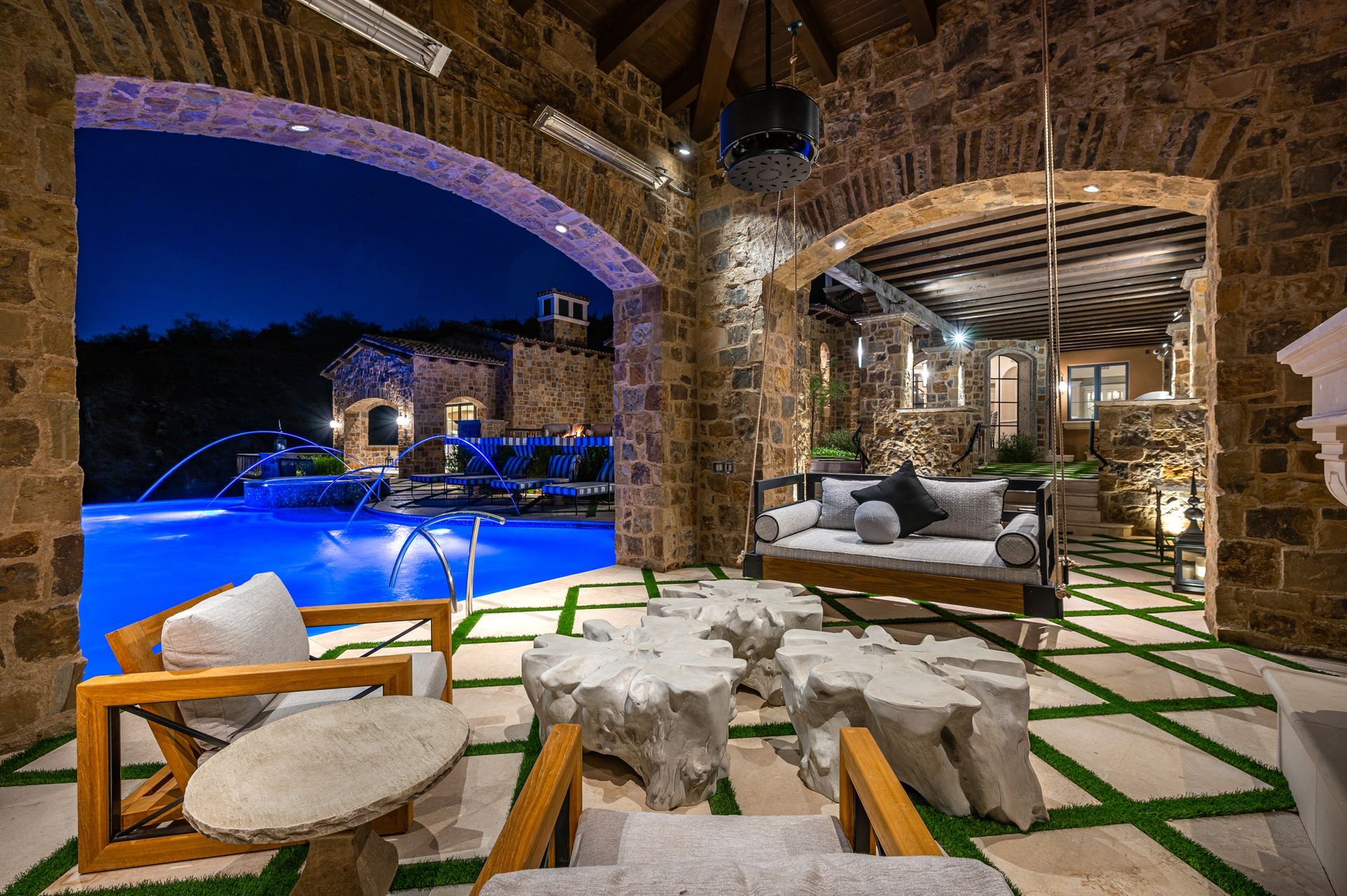 outdoor living area with luxury furniture overlooking a pool