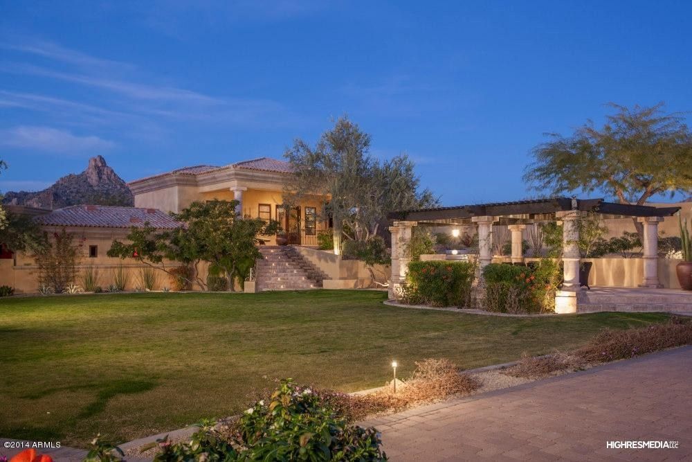 A large house with a large lawn in front of it.