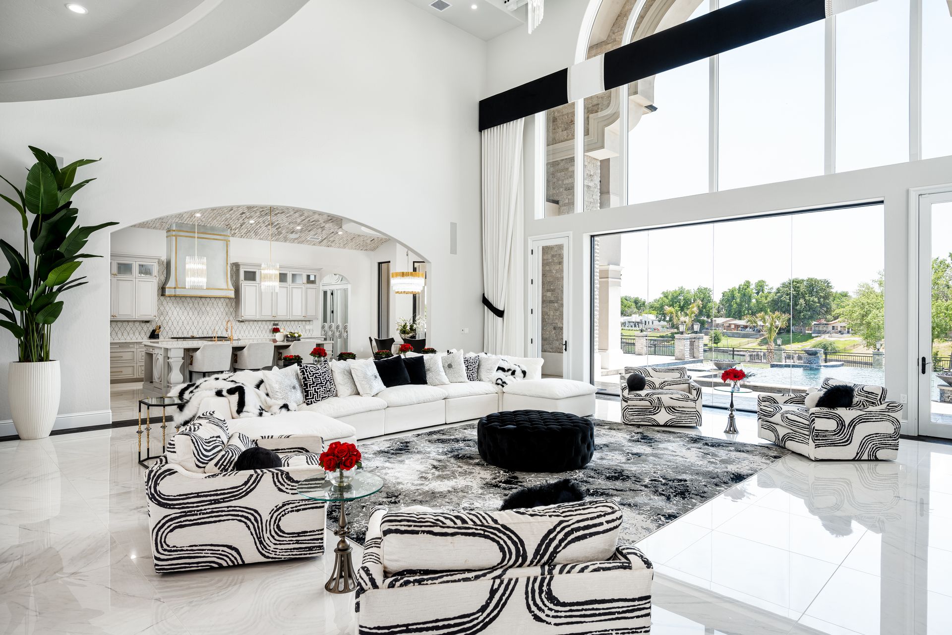 A living room with a lot of furniture and a large window