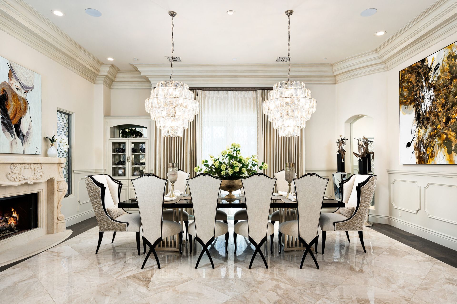 A dining room with a long table and chairs and a fireplace.