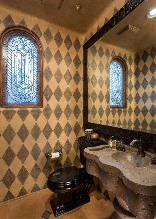 A bathroom with a toilet a sink and a mirror