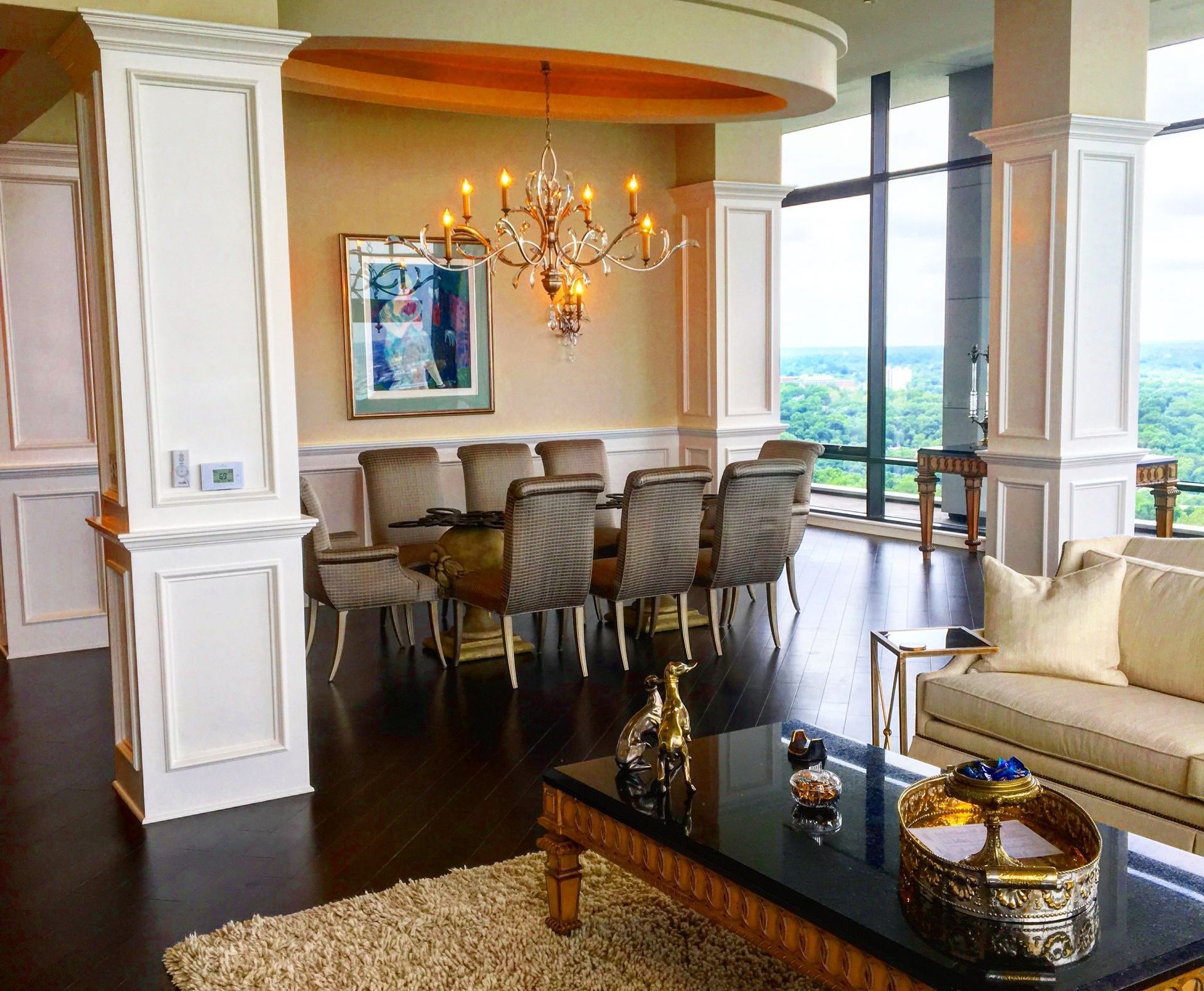 High-end residential dining room with curved ceiling soffit, and upholstered chairs