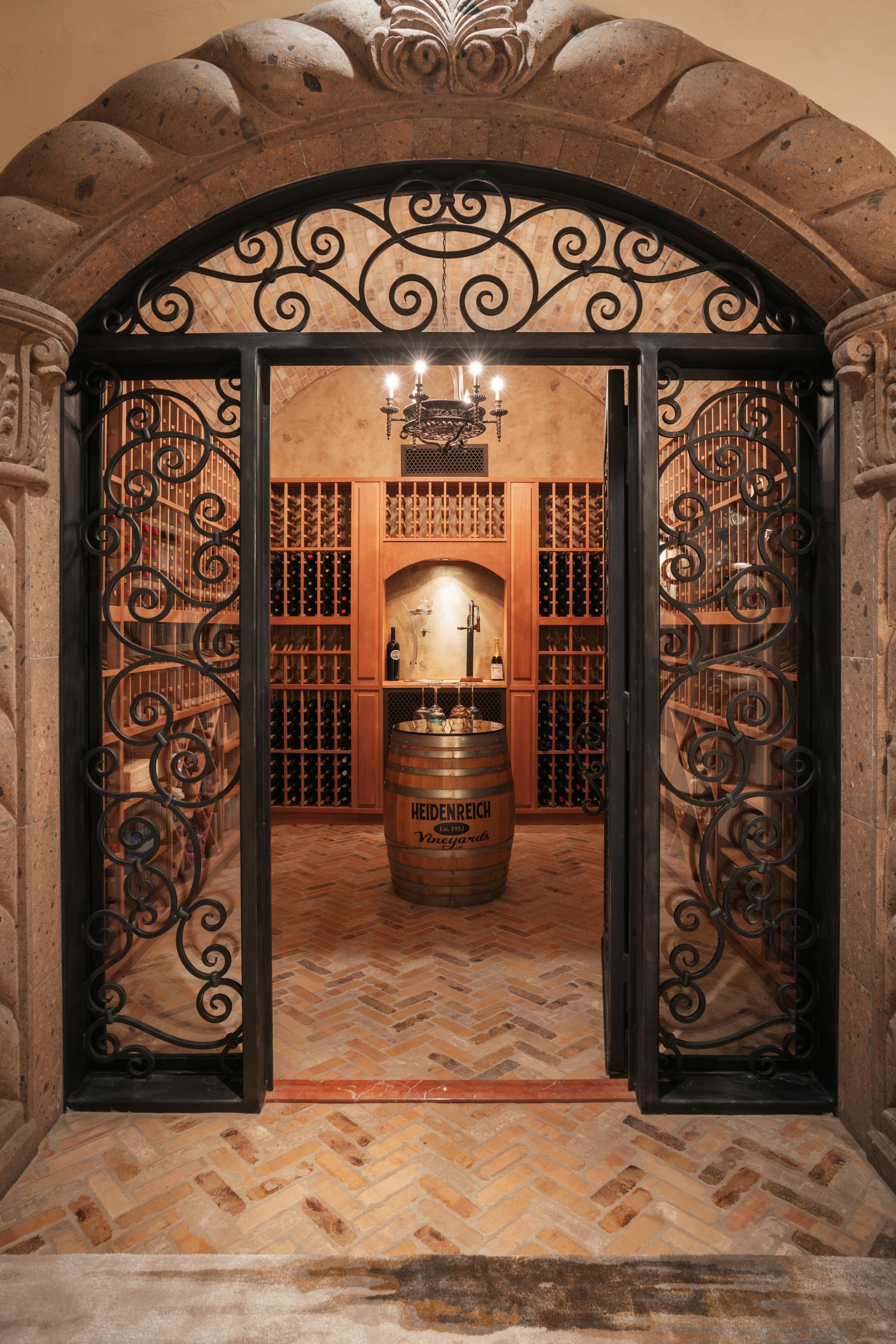 Wine cellar with decorative wrought iron gate and barrel.