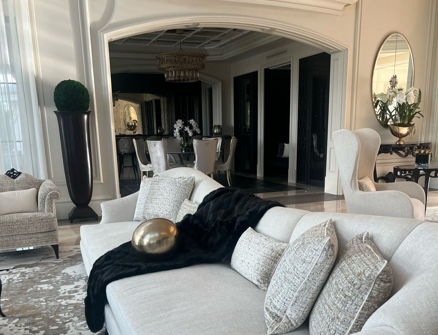 Refined luxury living space featuring soft textiles and elegant architectural framing