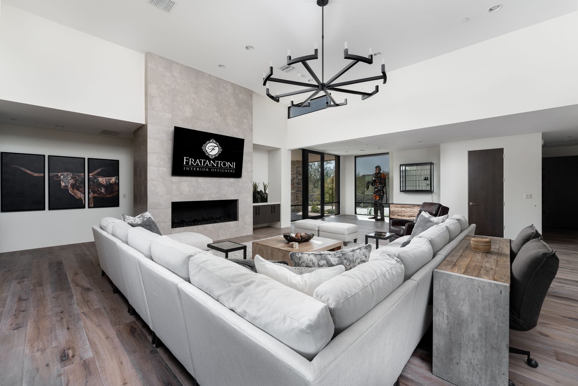 Modern living room with sectional sofa, fireplace, and large television.