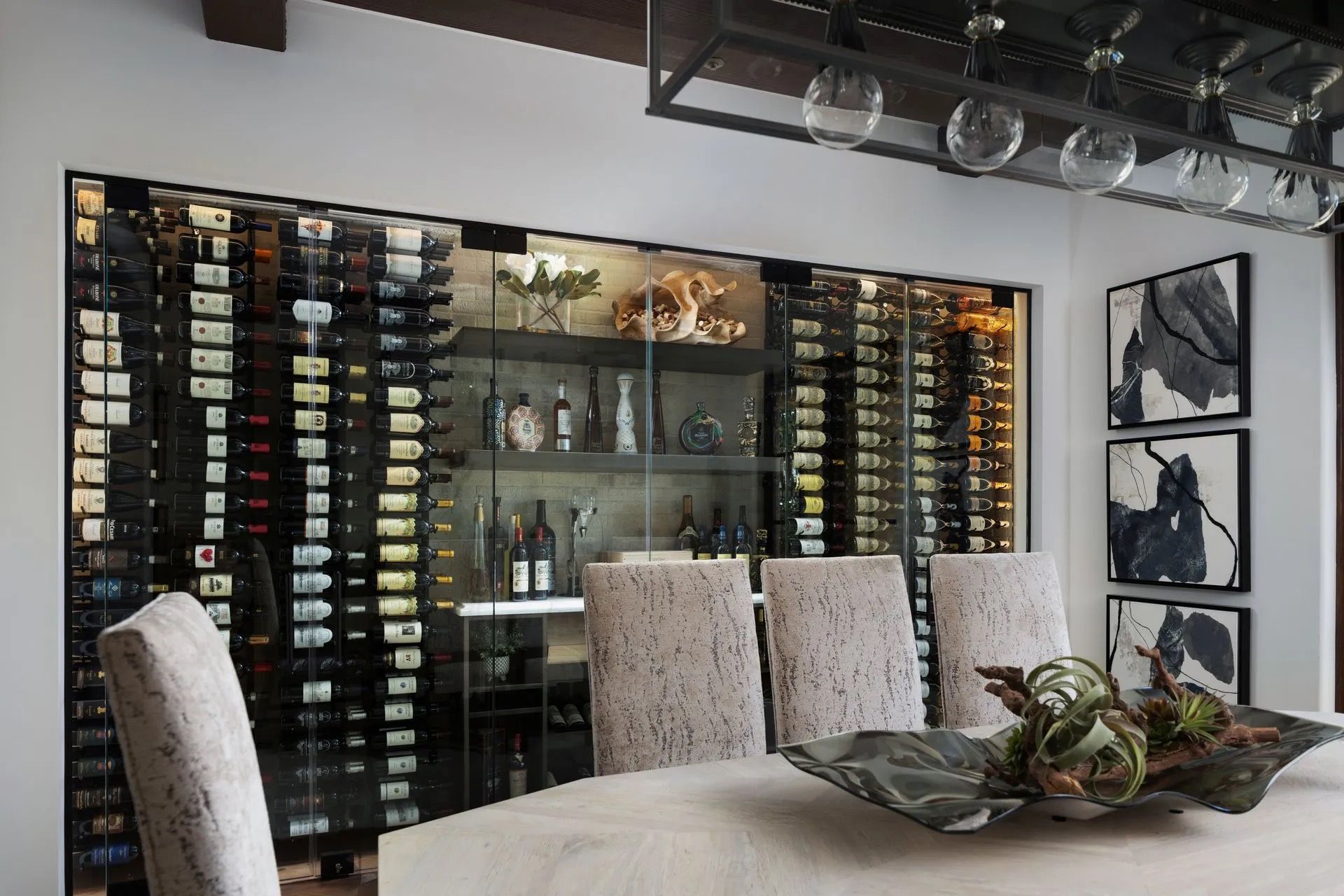 Dining room with built-in wine storage, table with centerpiece, and chairs.