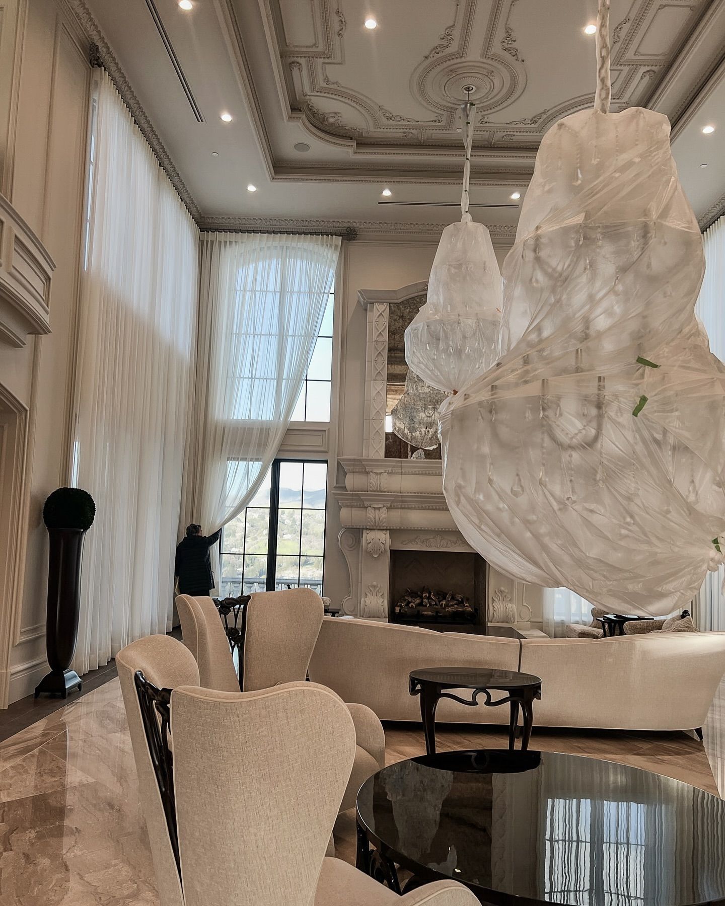 Luxury old world living room with ceiling details, sheer drapery, and custom furniture