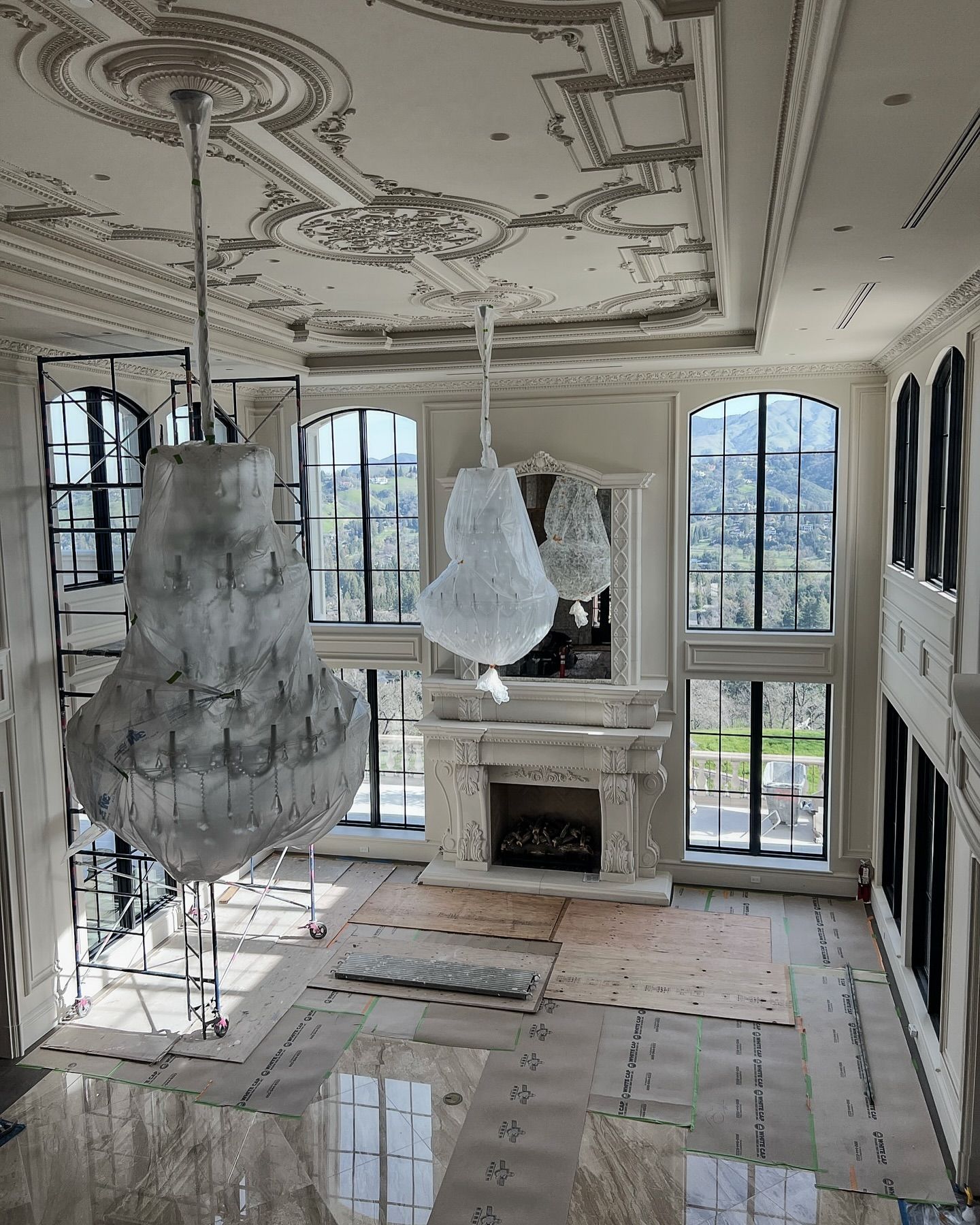 Luxury living room with ornate ceiling, expansive arched windows by Fratantoni Interior Designers