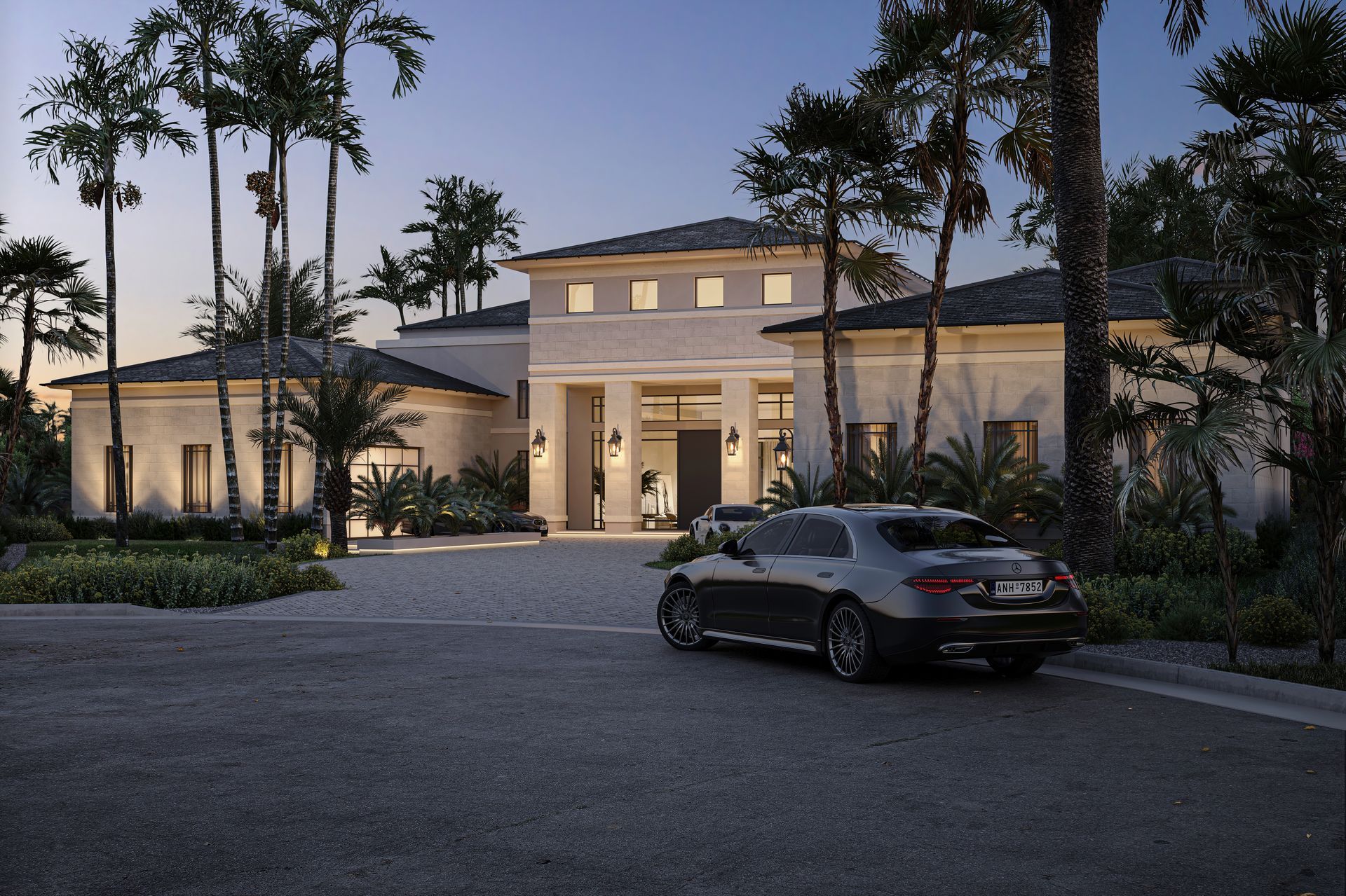 Luxury home with car parked in the driveway at dusk, surrounded by palm trees.