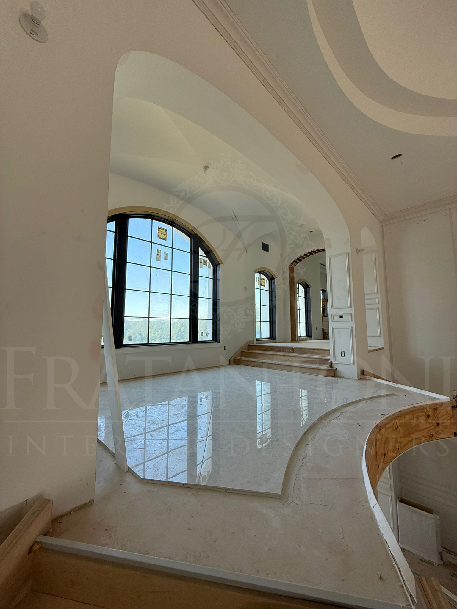 Empty modern entry balcony with curved white ceiling, large windows, and glossy marble floors designed by Fratantoni Interior Designers in scottsdale arizona