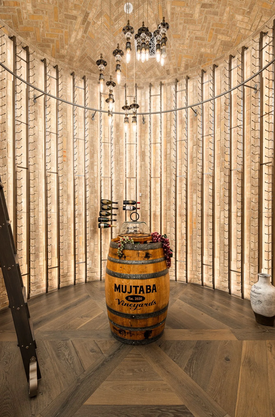 Wine cellar with wooden walls, barrel, and hanging lights.