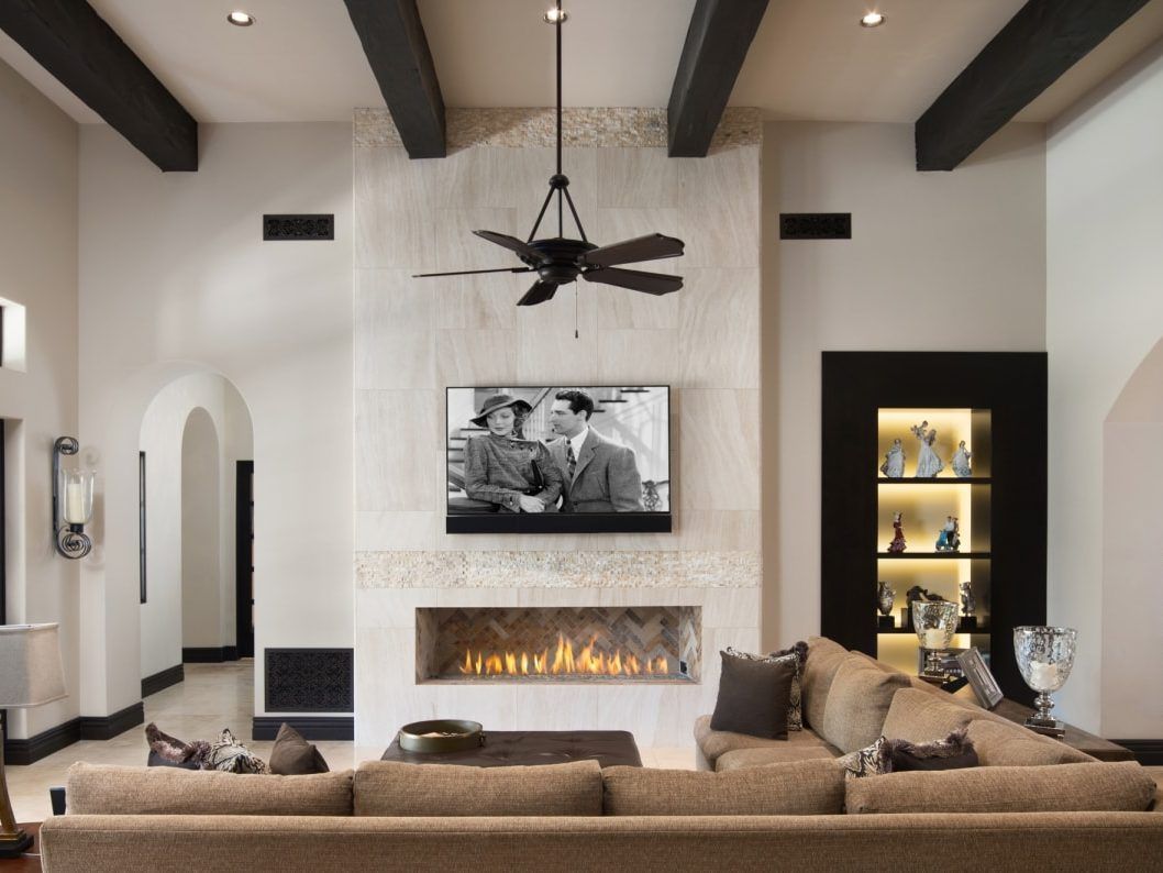 A living room with a fireplace and a flat screen tv