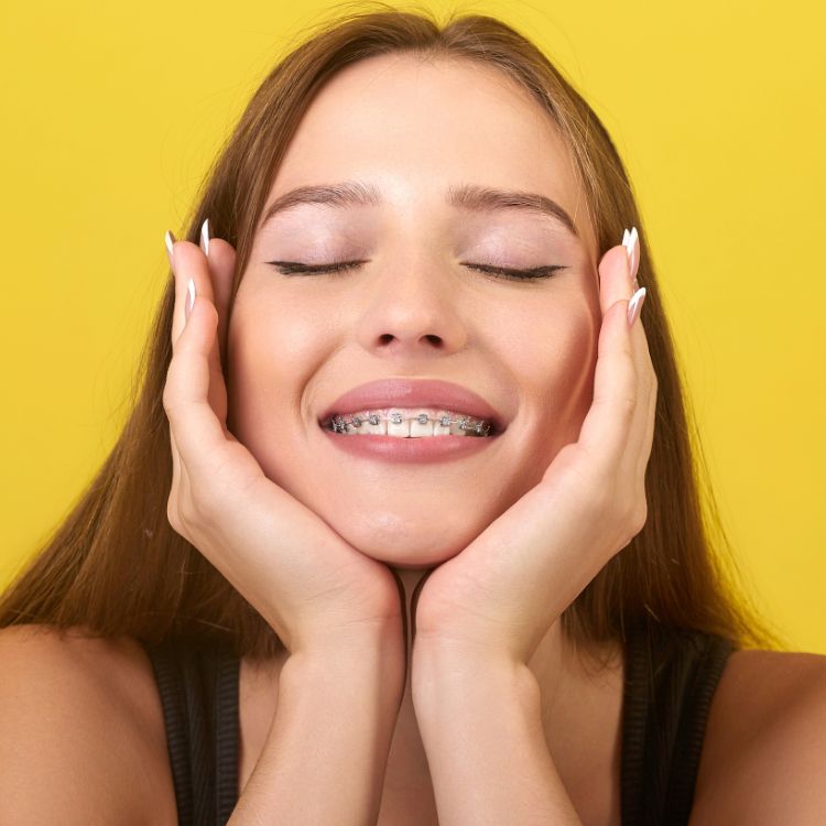 Woman looking at her new smile in the mirror