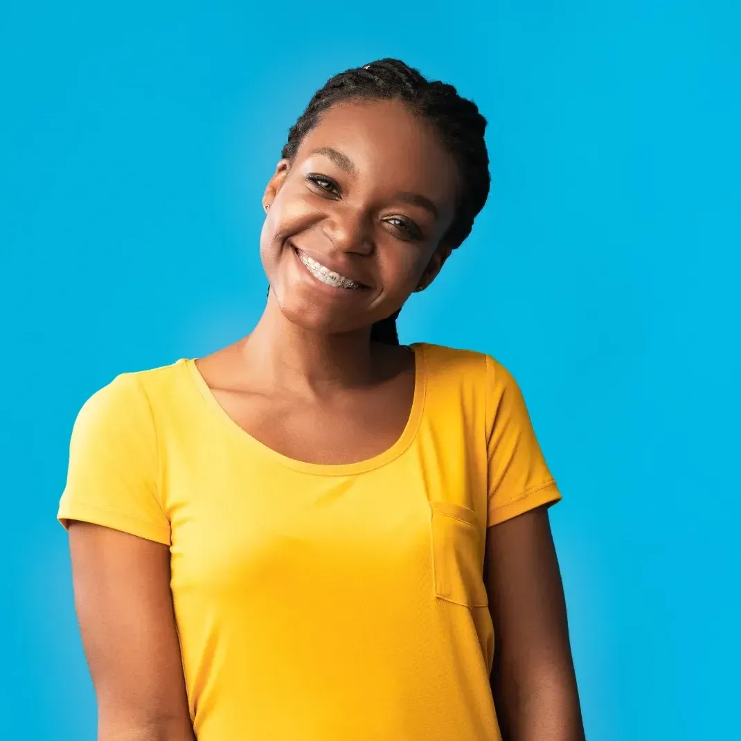 Teenage girl with yellow shirt and braces