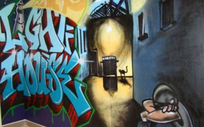 Graffiti on a wall that says lighthouse on it