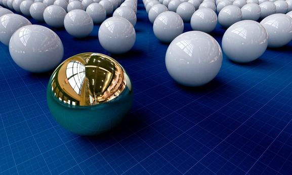 A group of white balls are lined up on a blue surface
