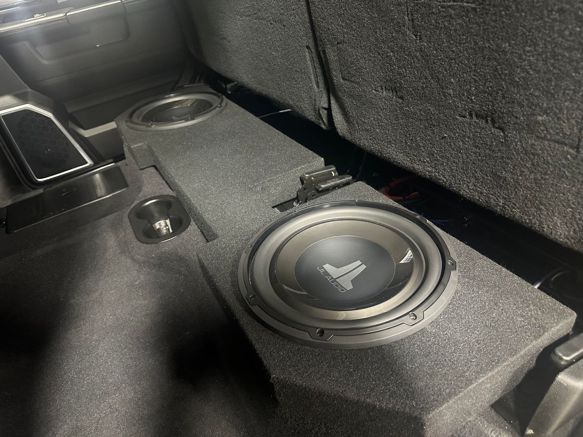 A subwoofer is sitting in the back of a car.