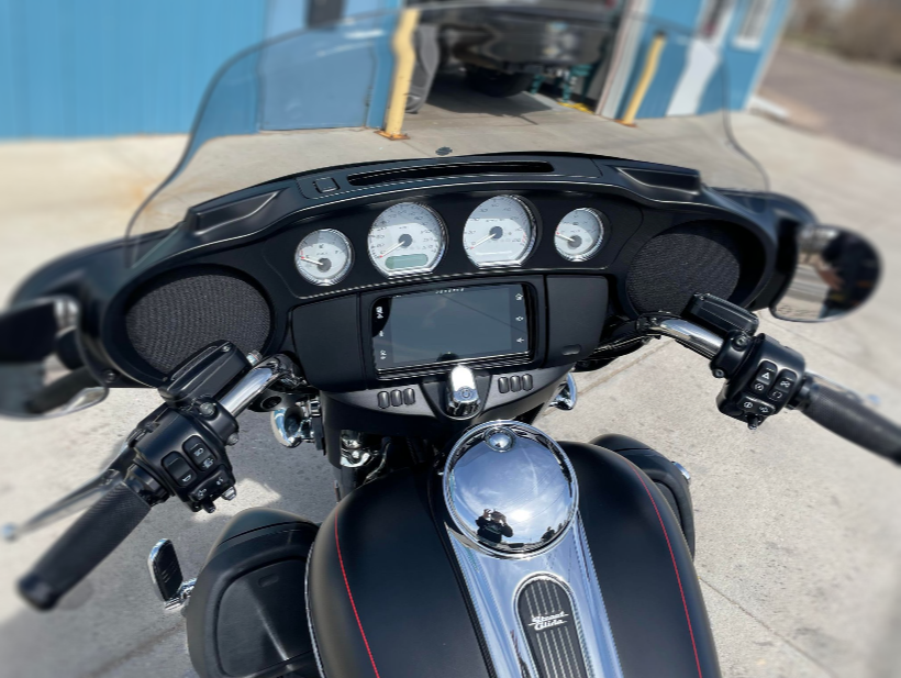 A harley davidson motorcycle is parked on the side of the road