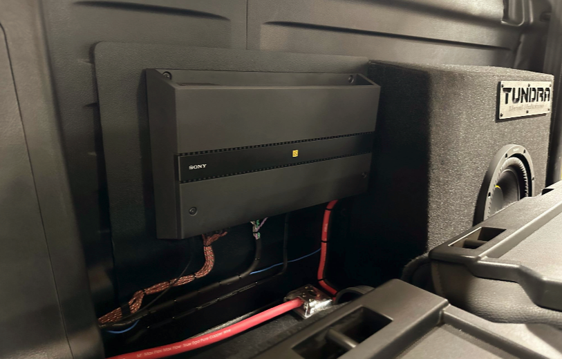 There is a subwoofer in the back of a truck.