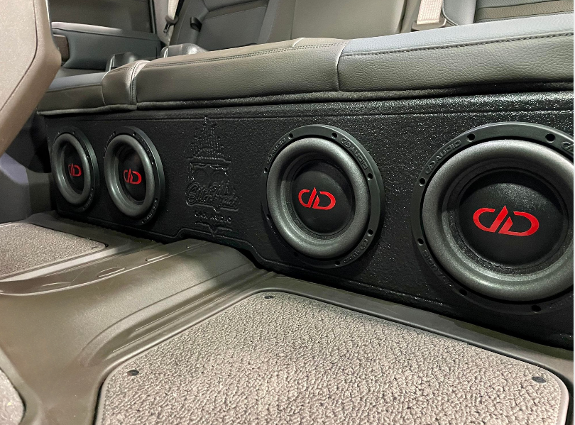 A car with a subwoofer in the back seat.
