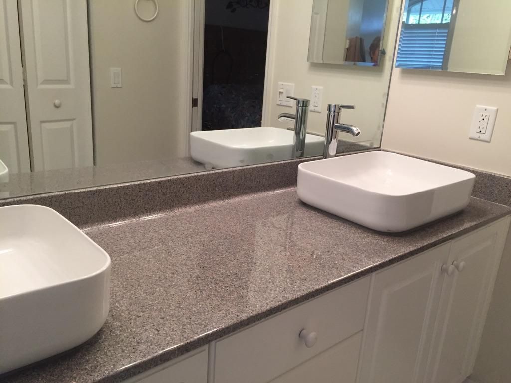 A bathroom with two sinks and a large mirror