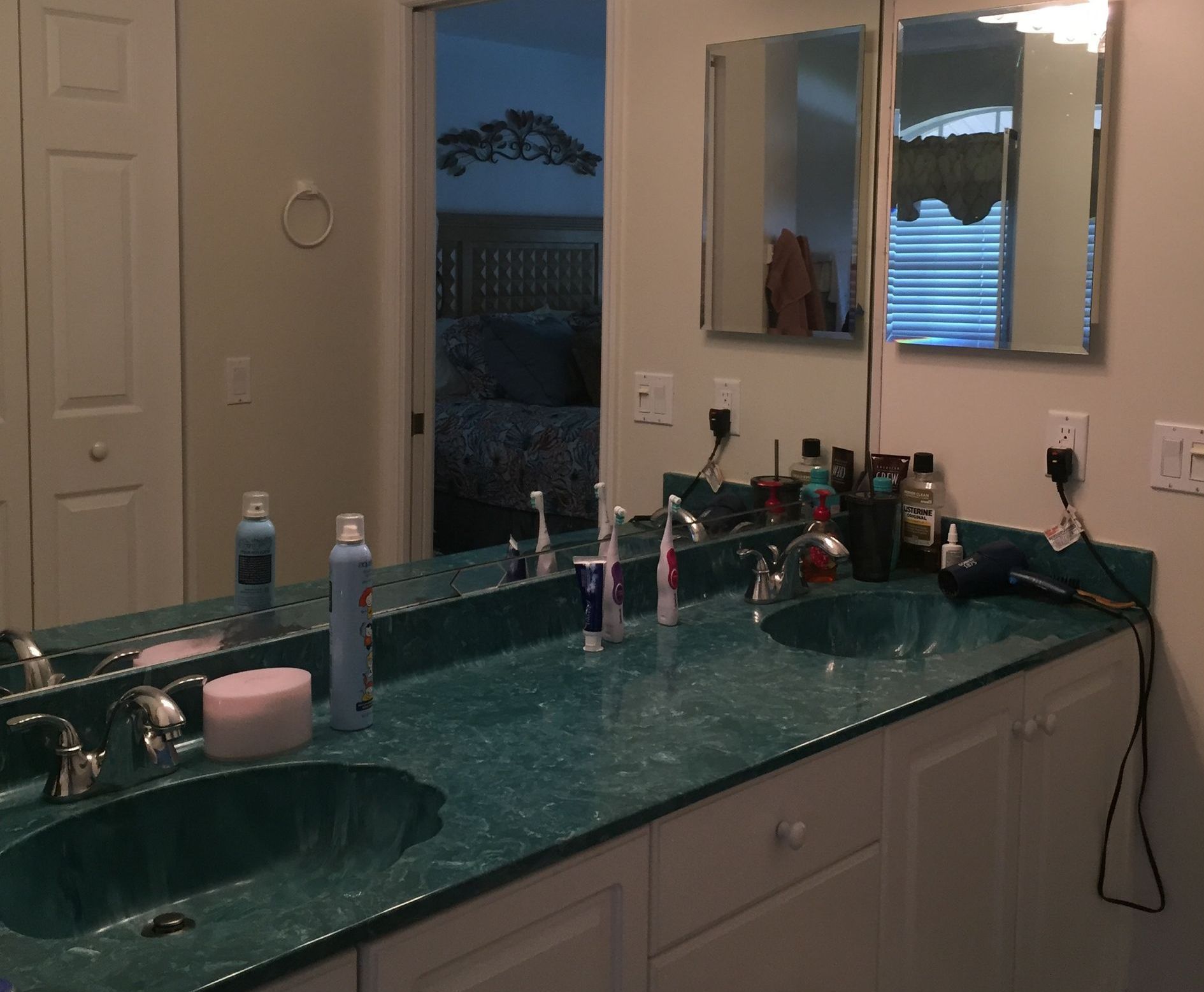 A bathroom with two sinks and a mirror