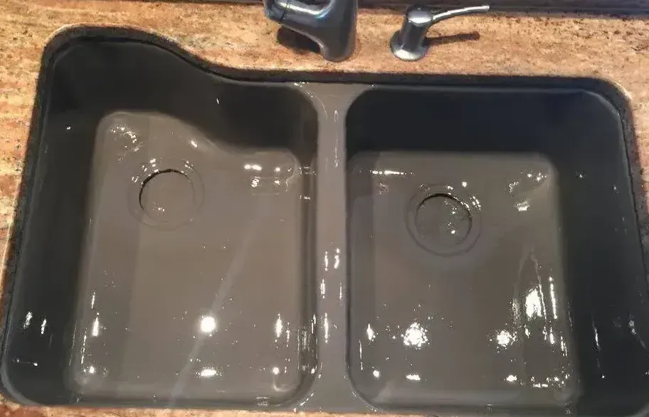 A refinished kitchen sink refinished in Kohler Ice Grey