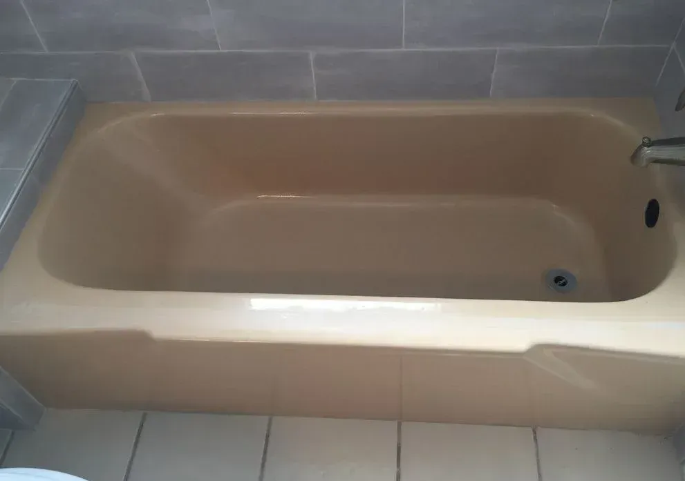 A bathtub is sitting in a bathroom next to a toilet.