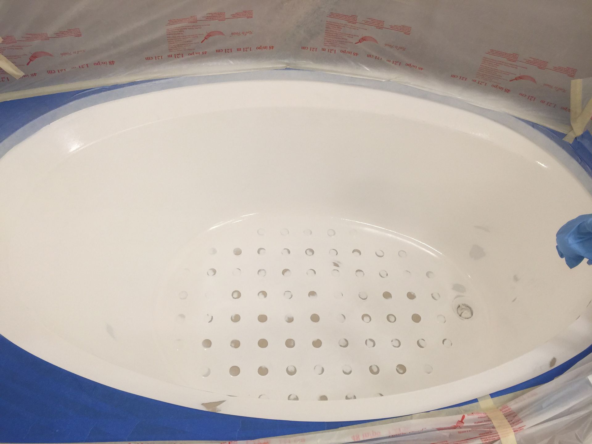 A white bowl is sitting on top of a blue table