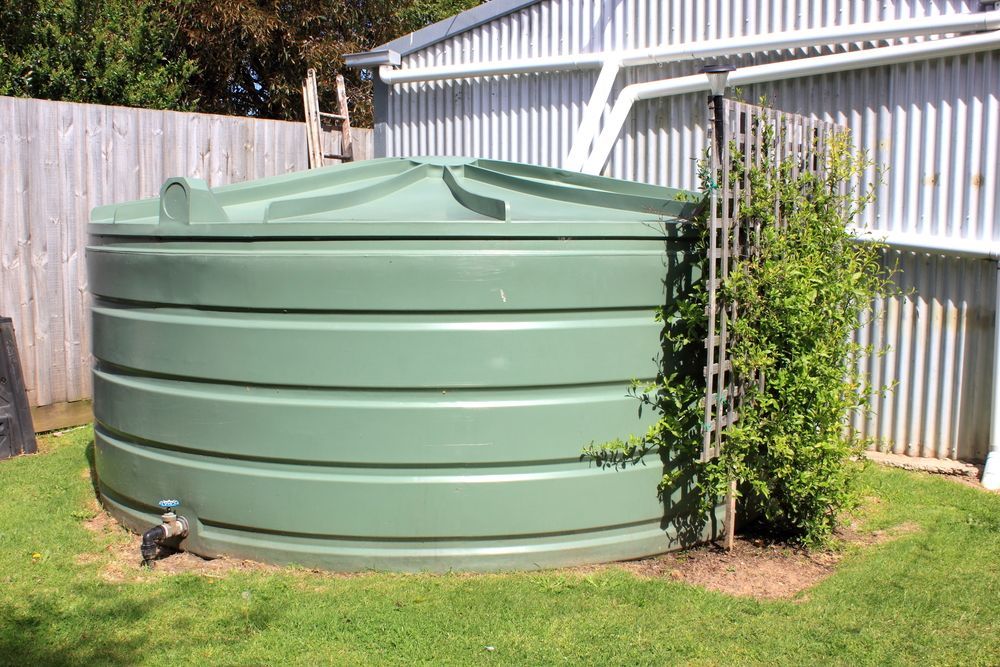 A Large, Sage-green Cylindrical Rainwater Tank — Tamworth Water Cartage in Duri, NSW