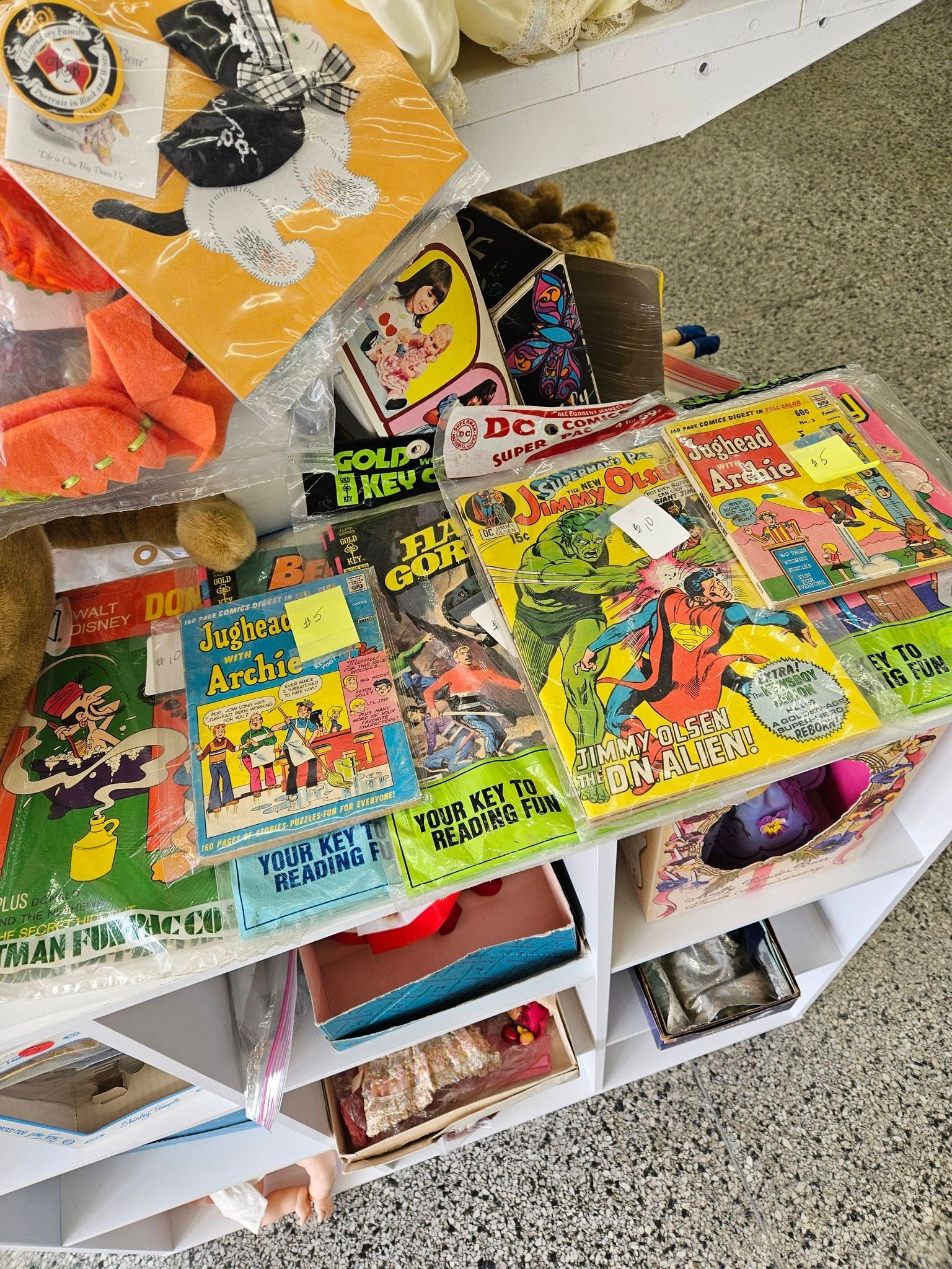 Open toy bins filled with colorful vintage comic books and magazines