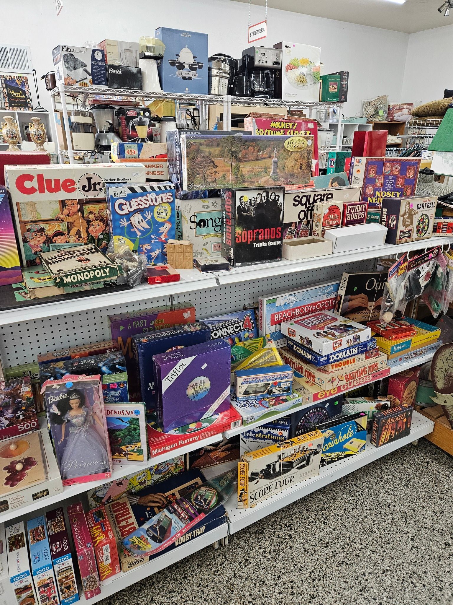 Store shelves filled with colorful board games and puzzles in a retail aisle