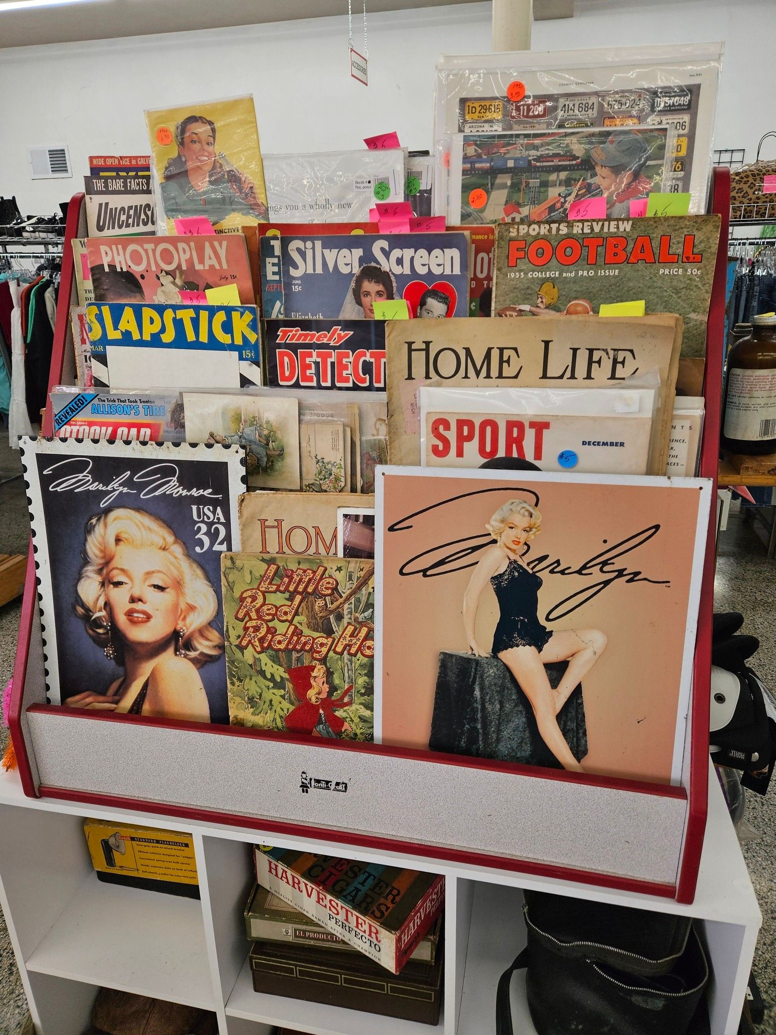 Vintage magazine display on a shelf, with colorful covers including Home Life, Sport, and other retro publications