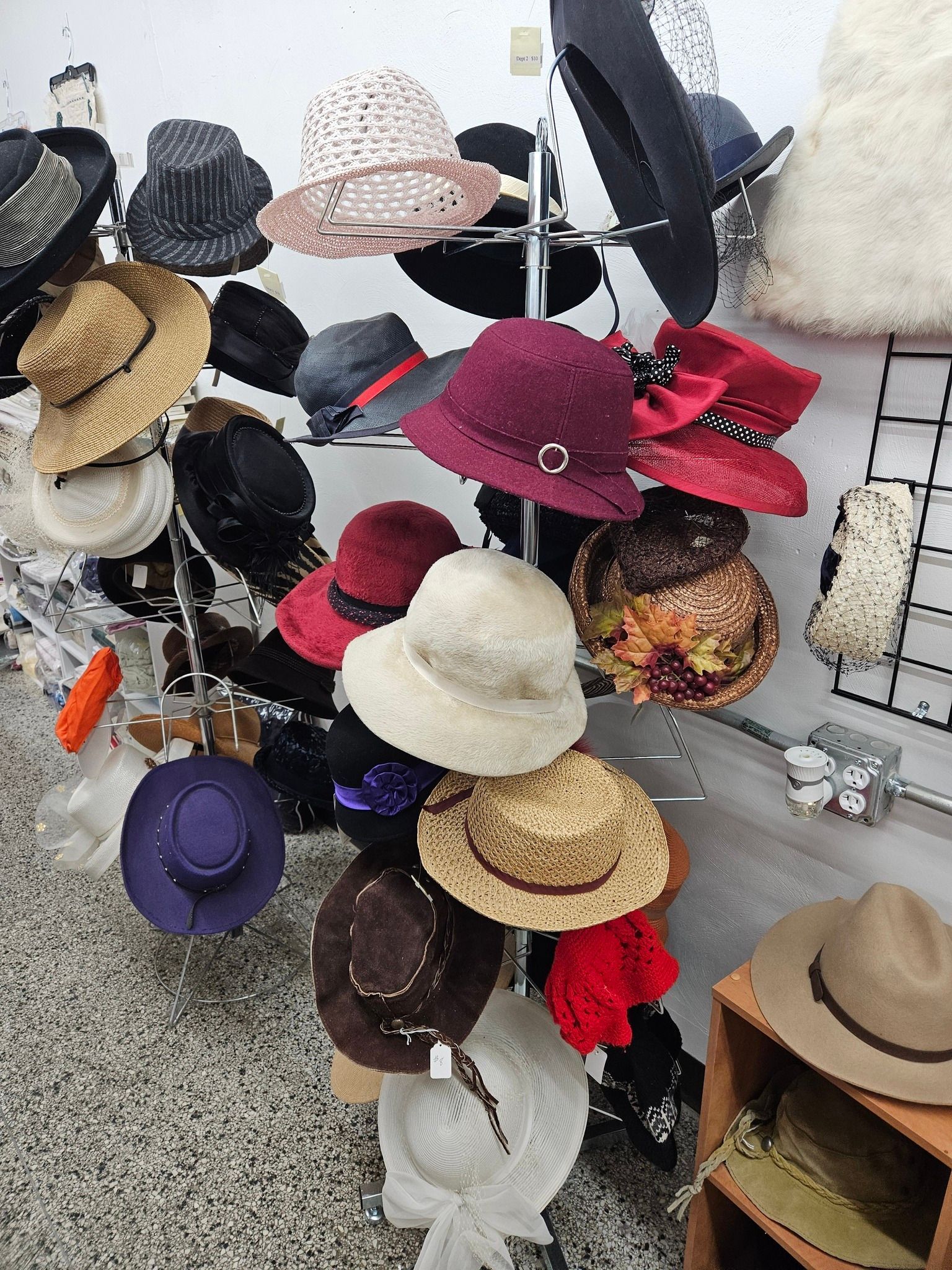 Display of assorted colorful hats on a rack in a store