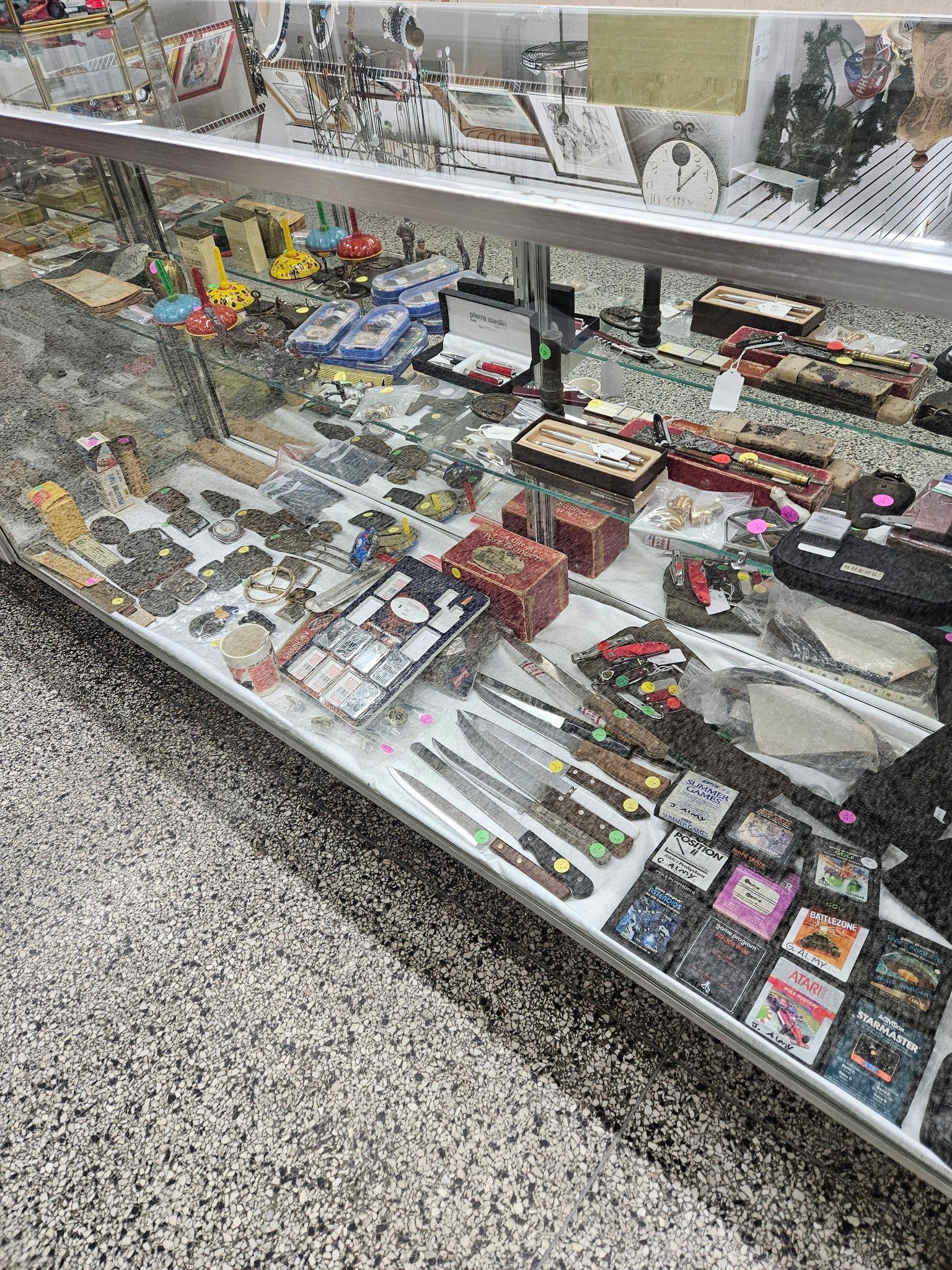 Glass display case with assorted small packaged items and accessories in a store