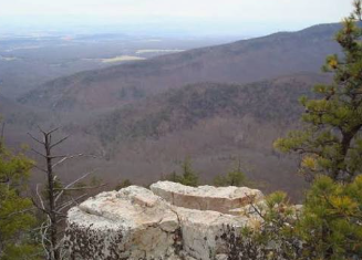Keswick, VA logo with a red star over a gray Virginia silhouette Rocky overlook with mountain ridges and a hazy valley under a pale sky