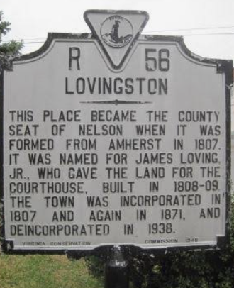 Historic roadside marker for Lovingston, with black text on a weathered white sign.
