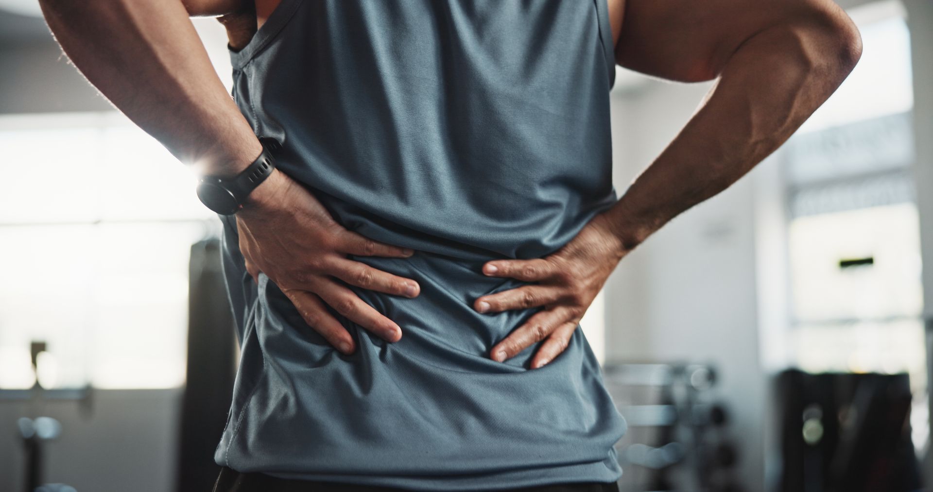 Man holding his lower back in pain.