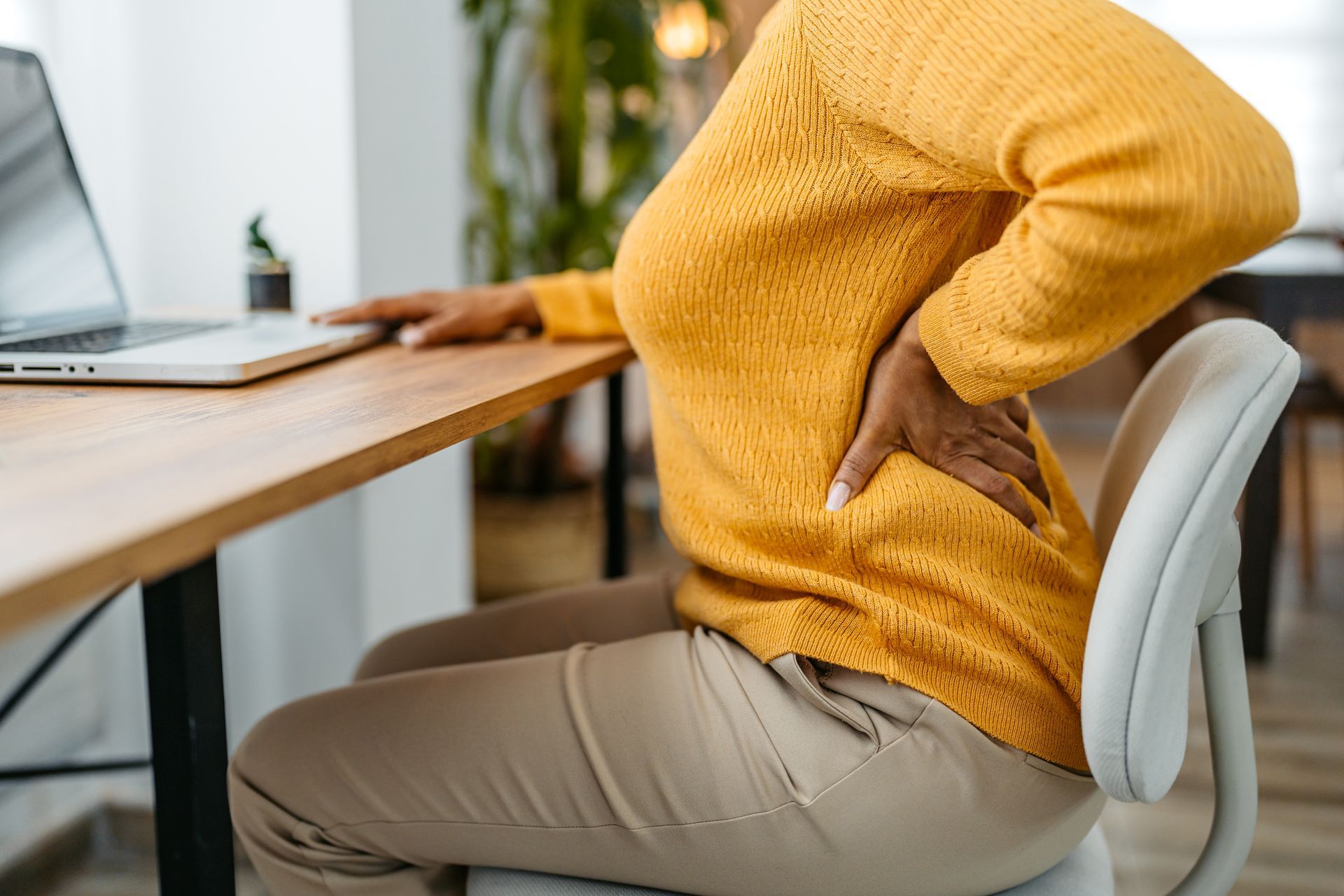 Man holding his lower back in pain.