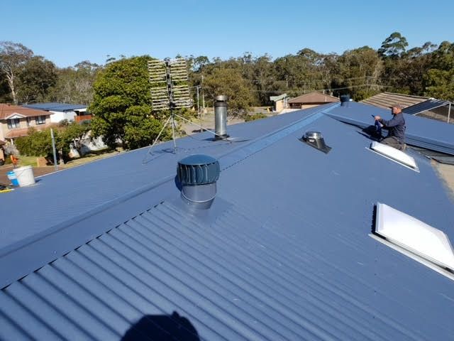 A Blue Roof With a Wind Turbine on Top of It — Coast Metal Roof & Gutter In Gosford, NSW