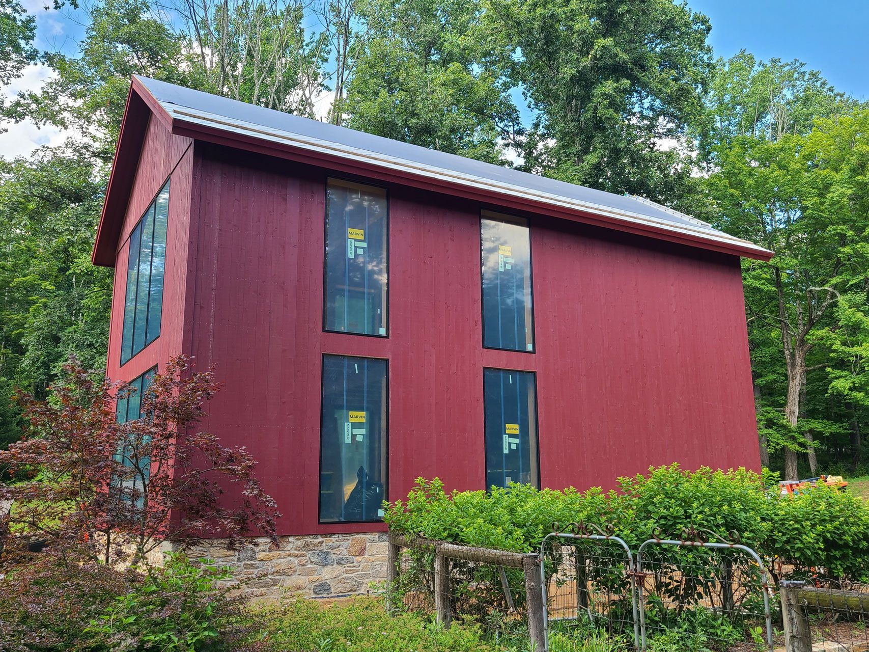 An empty attic with wooden beams and windows.