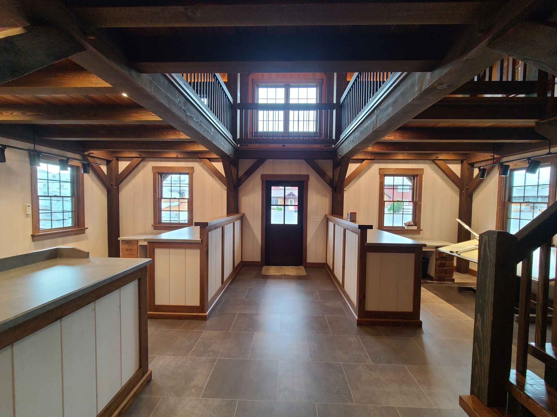 The inside of a wooden building with stairs and doors