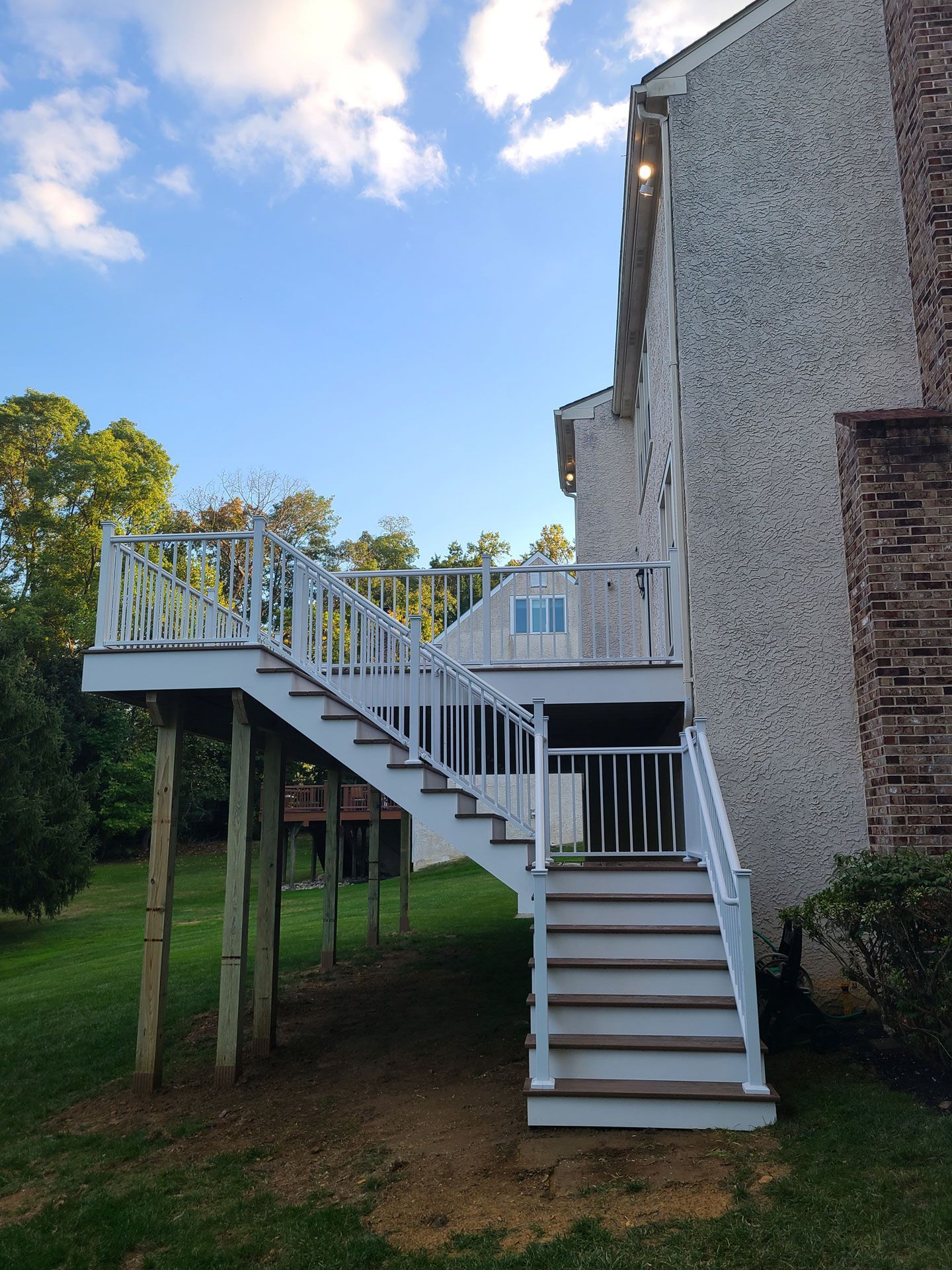 A house with a deck and stairs leading up to it.