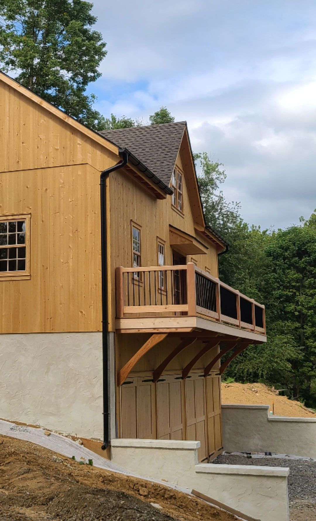 The back of a house with a large deck and stairs.