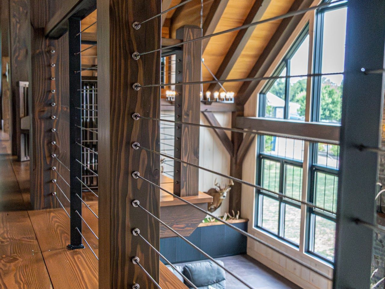 A living room with a couch and a lot of windows.