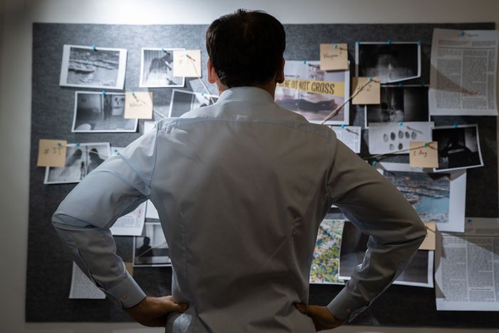 Private Detective Searching Crime Investigation Board
