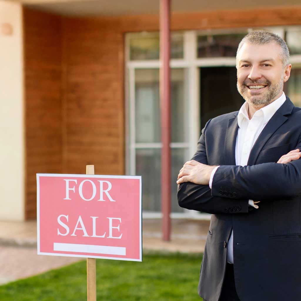 Man in suit with arms crossed next to