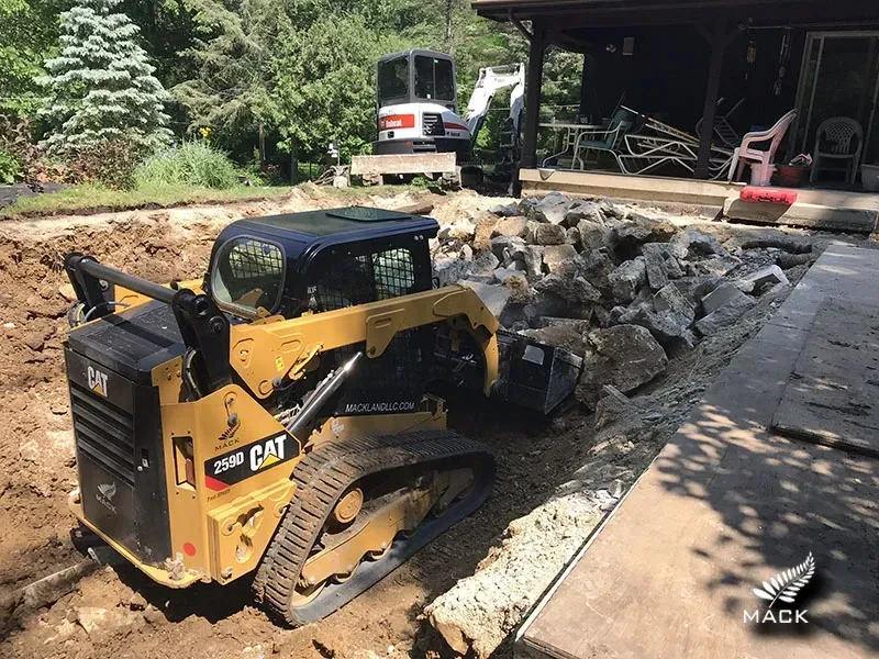 A track loader removing a pool in Moline, IL.