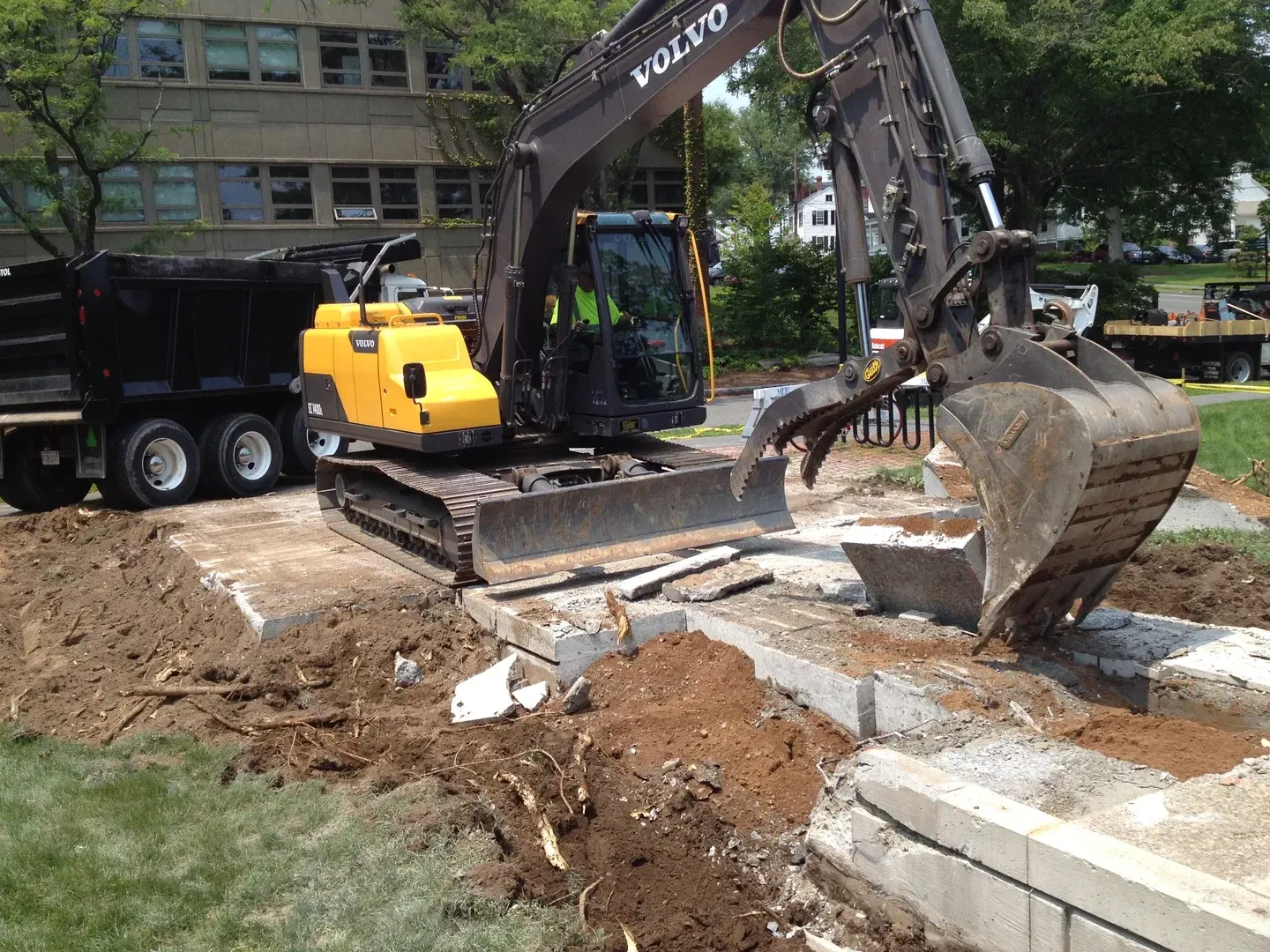 Excavator removing a driveway in near Davenport, IA.