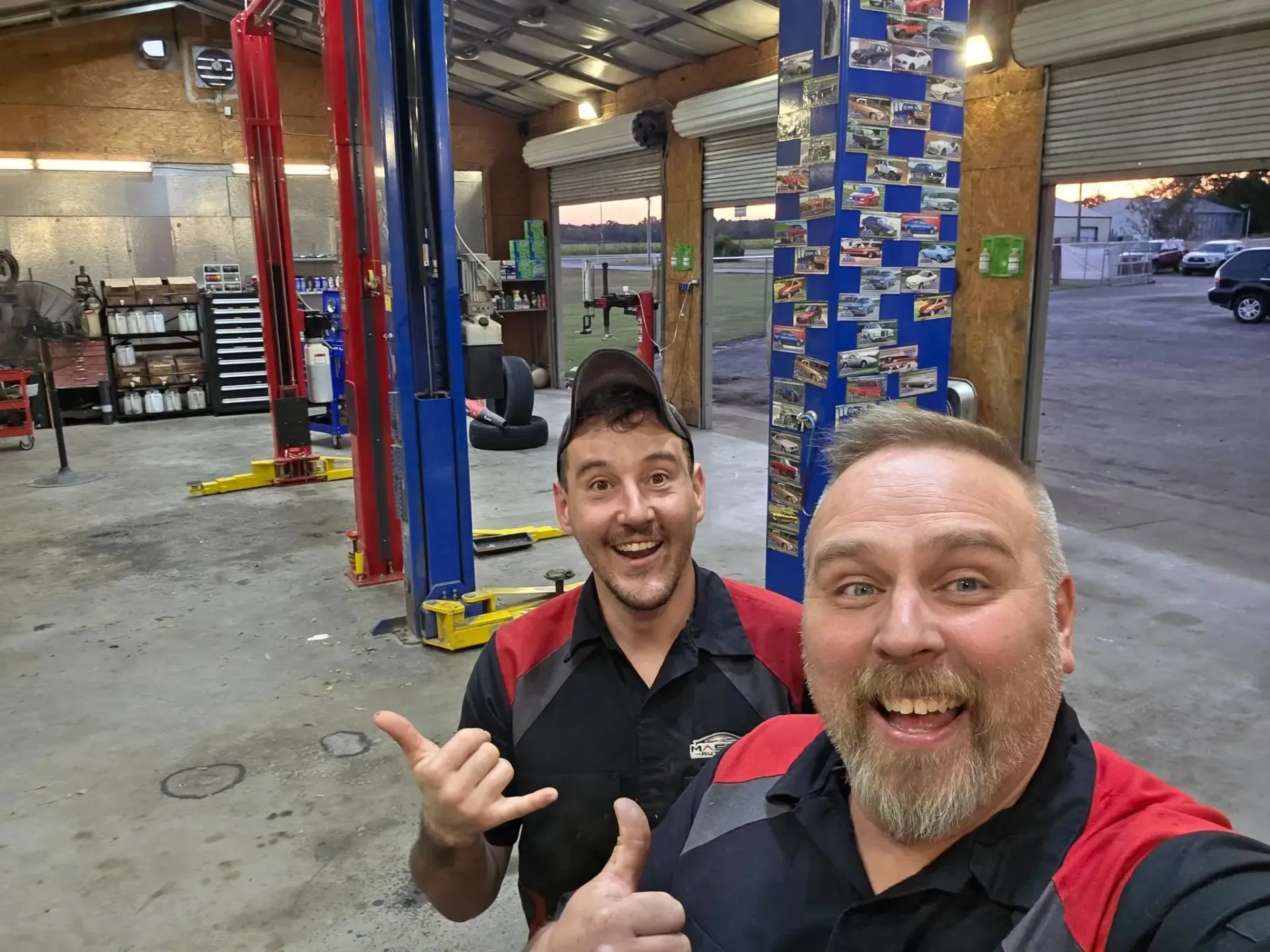 Team Members in Black-and-Red Uniforms | Masters Auto Group
